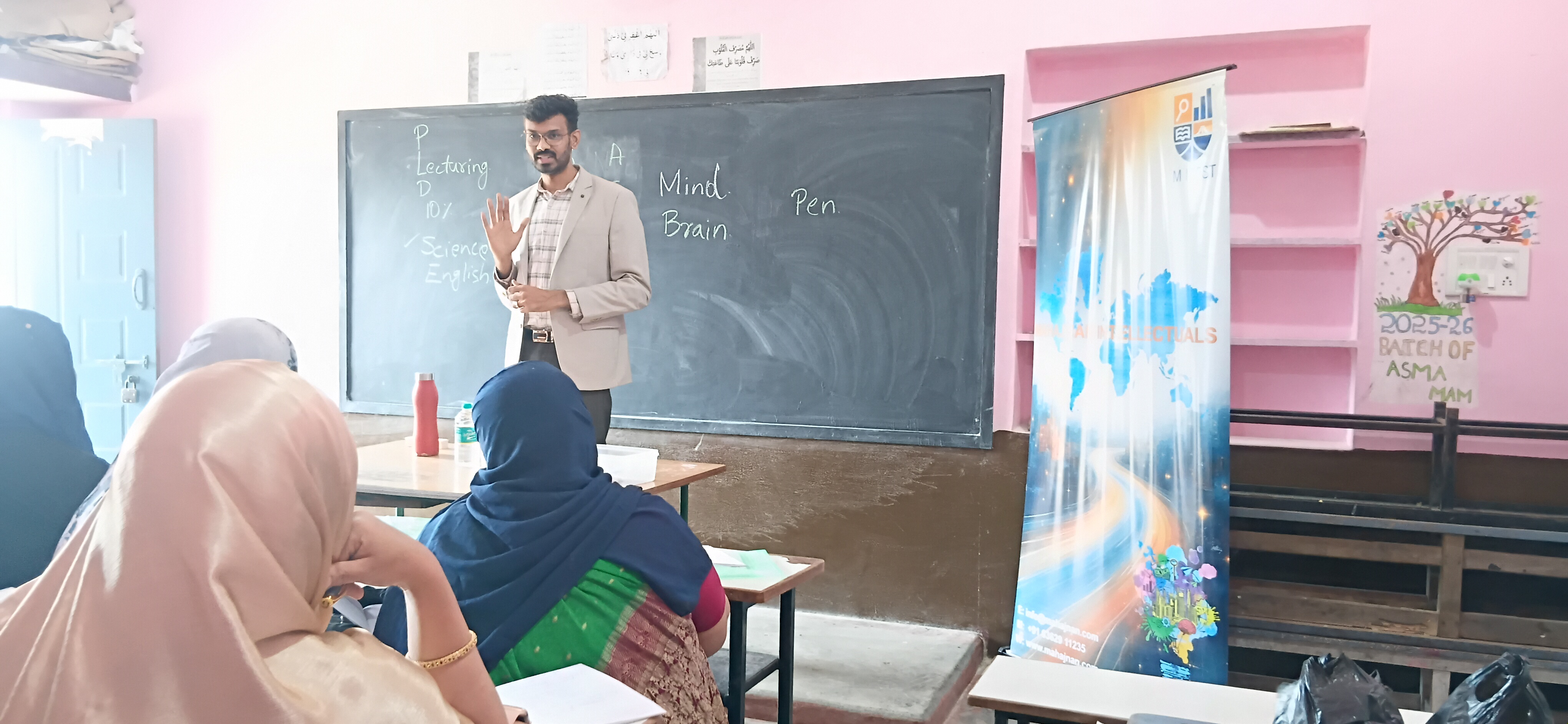 Resource person addressing teachers at the blackboard, Al-Falah Educational Institution, June 2026